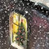 Beneath the Winter Dome — detail, window with a Christmas wreath